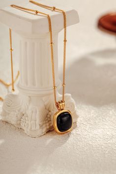 A symbol of strength and clarity, the black onyx in the "Nocturne" Square Necklace carries with it a quiet power. Known for its grounding properties, this natural stone offers protection and emotional resilience, while the 18k Gold Vermeil over sterling silver enhances its allure with a soft, golden glow. In its geometric simplicity, the square charm represents balance and stability, a perfect harmony between elegance and meaning. Materials: Natural black onyx, framed in 18k Gold Vermeil over st Timeless Black Pendant Necklace, Gold Spiritual Obsidian Jewelry, Timeless Black Enamel Necklace, Timeless Black Tarnish Resistant Jewelry, Black Onyx Timeless Jewelry, Elegant Obsidian Jewelry For Healing, Timeless Onyx Jewelry For Gifts, Timeless Black Onyx Jewelry, Black Onyx Jewelry For Meditation