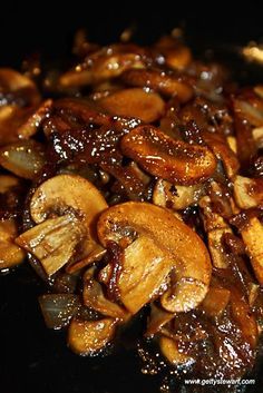 sliced mushrooms are being cooked in a frying pan