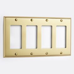 the three gang light switch plate is brass