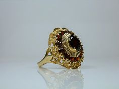 Vintage 18k Yellow Gold Garnet Ring Size 6. Ornate Setting. Natural Gemstones. Birthstone Jewelry Oval Multi-stone Ruby Ring, Oval Multi-stone Ruby Ring For Formal Occasions, Formal Multi-stone Garnet Rings, Antique Oval Garnet Jewelry, Formal Round Garnet Cluster Ring, Oval Multi-stone Ruby Ring In Yellow Gold, Antique Oval Cluster Ring As Gift, Oval Garnet Ring Hallmarked, Oval Multi-stone Garnet Rings