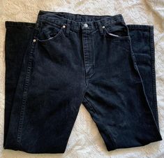 Vintage High Waist Women's Black Wrangler Jeans. Classic western style.  Brand: Wrangler; USA made Size on tag: 9X32 (please see measurements for accuracy as all brands are different) Fabric: 100% cotton denim MEASUREMENTS:  Waist: 15"/ 30 inches doubled Hips: 39" - taken at the bottom of the zipper opening Rise: 10.5" Inseam: 31.5" Thigh: 20" Good Vintage Condition - No notable flaws, but typical used garment wear and fading may be present. 90s Cowgirl, Black Wrangler Jeans, Cow Girl, Wrangler Jeans, Womens Jeans, Classic Vintage, Different Fabrics, All Brands, Western Fashion