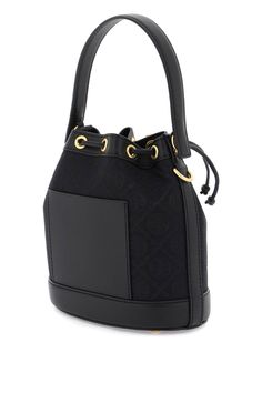 Tory Burch T Monogram bucket bag made of jacquard fabric with leather and tone-on-tone trims. Drawstring closure, fabric with one open leather pocket, additional leather patch pocket at back, single handle, adjustable and detachable shoulder strap and protective studs. Gold-finished metalware. Size Info STANDARD Color Detail Black Made In Cina Material 60%CO 40%PL Season One spring Season Two summer Product bags Brand Tory Burch Size And Fit Bag Length = 20,5 cm, Bag Height = 21,5 cm, Handle Hei Bucket Bag With Detachable Handle In Coated Canvas, Bucket Bags With Detachable Handle In Coated Canvas, Bucket Bag With Detachable Strap And Double Handle, Double Handle Bucket Bag With Detachable Strap, Travel Bucket Bag With Detachable Strap In Monogram Canvas, Designer Monogram Canvas Bucket Bag With Top Handle, Designer Tan Bucket Bag With Leather Handles, Luxury Monogram Canvas Bucket Bag With Double Handle, Designer Tan Bucket Bag For Travel