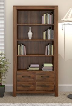 a bookshelf with many different types of books on it in a living room