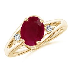 an oval ruby and diamond ring in yellow gold