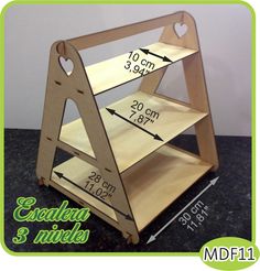 a small wooden shelf with measurements for the top and bottom shelves on it, sitting on a table