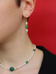 "DETAILS - Natural freshwater pearls - Green pressed malachite - Base of the earrings is gold covered - Total strand length is 1.6\" - Total strand length is 4 cm QUALITY The high-quality materials I use in my jewelry are truly exceptional. They are carefully selected by me and come from trusted suppliers with whom I have a good relationship. Their timeless beauty and elegance make them an essential component of any jewelry collection. Whether it's a classic pearl necklace or a contemporary design, my high-quality pearls add sophistication and luxury to any outfit. View my entire shop here: https://www.etsy.com/shop/ToriaJewelryDesigns?ref=seller-platform-mcnav GIFTING Your necklace will arrive in a Toria jewelry gift bag to keep it safe during transit or ready for gifting. Multiple items Green Pearl Charm Drop Earrings, Elegant Malachite Earrings, Green Dangle Pearl Earrings For Pierced Ears, Green Drop Earrings With Pearl Charm, Single Green Pearl Drop Earrings, Green Pearl Drop Earrings For May Birthstone, Elegant Gold Malachite Earrings, Green Emerald Earrings With Pearl Drop, Green Pearl Earrings