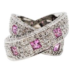 Gorgeous, ultra-feminine pink sapphire and pave diamond crossover band ring. This pretty, contemporary style ring glitters from all directions with sparkling pave set diamonds, while the playful pink sapphires add a pop of color and interest. You will absolutely love how this ring just shines on your finger! This stunning 14 karat white gold band ring features 198 natural white pave diamonds, G-H in color, SI1-SI2 in clarity and totals 2.88 carats. The pave diamonds are embellished throughout th Pendant Sets, Diamond Pendant Sets, Crossover Ring, White Gold Set, Jewelry Appraisal, Gold Band Ring, White Gold Band, Women Diamond, Sapphire Stone