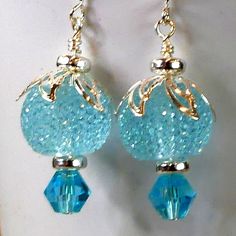 These earrings attract the right kind of attention.  Their delicate aqua color combines with bright silver, crystal and a large striking textured ball to create a sophisticated earring with a smart design.  One of a kind Elegant Turquoise Crystal Earrings Nickel Free, Elegant Turquoise Nickel-free Crystal Earrings, Elegant Light Blue Round Bead Earrings, Elegant Light Blue Round Beaded Earrings, Pumpkins Crafts, Diy Pumpkins Crafts, Diy Pumpkins, Aqua Earrings, Diy Pumpkin