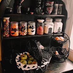 a shelf filled with lots of different types of jars and containers on top of it