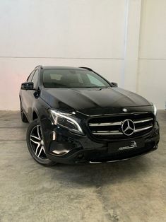 a black mercedes gle is parked in a garage