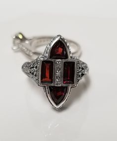 "Thanks for shopping our vintage estate store. We tend to sell well below wholesale and truly hope you enjoy all of our items. Many of the items are one of a kind, so please enjoy scrolling through the pictures and hopefully something will catch your eye. Black spots are from camera. Nice estate sterling silver 925 red fire 1.5ct garnet gems cocktail filigree ring. Custom made item from our shop, meaning we added the gems into the setting.  Ring size: 8 Setting: 5/8\" 12mm by 3/4\" Band width: 2mm Weight: 4.54 grams Garnet is created. Beautiful victorian setting. Marked sterling." Champagne Diamond Earrings, Garnet Gem, Authentic Jewelry, Gem Ring, Champagne Diamond, Filigree Ring, Red Fire, Black Spot, Eye Black