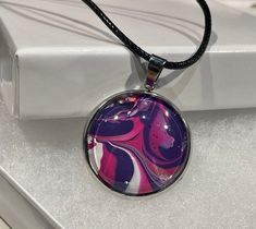 "These are one of a kind necklaces that have a hand painted painting set in a pendant, with a glass cover on top. Each comes with it's own certificate of authenticity and has been made in house in small series. These are colorful and unique pieces that you can dream into as they look different from each angle you view them. It comes with an 18\" necklace. They are perfect as a gift for yourself or someone you care about." Necklace Painting, South Orange Nj, Purple Swirl, Painting Set, Glass Cover, Paint Set, Pendant Necklaces, Unique Pieces, Necklaces