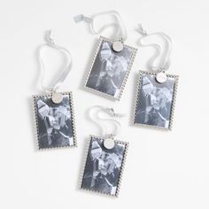 four pictures hanging from strings on a white background with the string attached to each photo