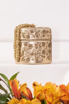 Gold potli style bag embroidered with sequins and cutdana embellishments. Comes with chain link handle. - Aza Fashions Gold Evening Bag With Zari Work, Designer Gold Evening Bag For Festive Season, Festive Gold Designer Evening Bag, Designer Gold Evening Bag For Festive Occasions, Gold Potli Bag With Zari Work For Evening, Evening Gold Potli Bag With Zari Work, Luxury Gold Clutch Potli Bag, Evening Gold Bag With Zari Work, Rectangular Gold Embroidery Evening Bags