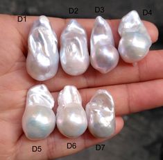 four different types of pearls in someone's hand