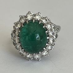 White gold (18k) ring adorned with a cabochon emerald surrounded by brilliant-cut diamonds. Weight of the emerald: approximately 6 ct (12.6 x 11 x 6.4 mm). Gross Weight: 8.39 g. Size: 60 Possibility of sizing, contact us. Further information : We issue an invoice as well as a certificate of authenticity established by our qualified gemologist (LFG Paris). Our photos are not reworked and are taken in a natural light environment. We can send you a short video upon simple request. Each piece of jew Emerald Cabochon, Etsy Gold Ring, White Gold Ring, Multi Stone Ring, Multi Stone, Brilliant Cut Diamond, Short Video, White Gold Rings, Diamond White