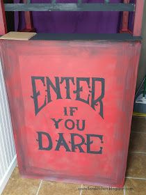 a red box with the words enter if you dare painted on it in black ink