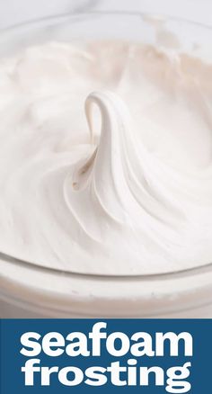 a bowl filled with white frosting sitting on top of a table