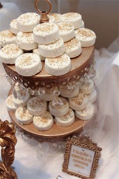 a three tiered cake stand with cupcakes on it