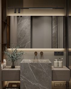 a bathroom with marble counter tops and two vases on the sink, surrounded by candles