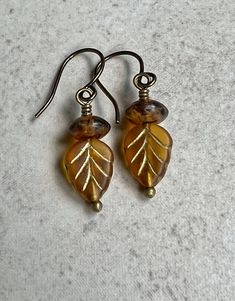 "small leaf earrings   yellow brown czech glass earrings  boho dangle Small, 10mm, Czech glass leaves are matte honey yellow with metallic gold color, etched veining. Each is topped with a matte amber brown glass saucer bead. Small hook ear wires are antiqued brown.  Length of earrings from top of ear wires is 1 1/4\". Glass leaves measure 10mm long. You can enter my sop here: gypsydangles.etsy.com" Metallic Gold Color, Unique Rings Vintage, Honey Yellow, Beaded Jewelry Necklaces, Brown Earrings, Amber Brown, Small Leaf, Jewelry Outfit, Earrings Boho