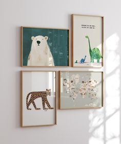 three framed pictures hang on the wall with animals and giraffes in them