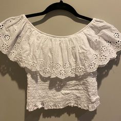 Off The Shoulder White Blouse With Flower Detailing. From A Little Shop In France. Never Worn. Size Xs-S White Cropped Off-shoulder Top For Spring, Casual Cropped Off-shoulder Top With Ruffles, Summer Off-shoulder Top With Ruffles, White Off-shoulder Short Sleeve Top For Spring, White Short Sleeve Off-shoulder Top For Spring, White Off-shoulder Top With Short Sleeves For Spring, White Cropped Off-shoulder Top, White Cropped Off-shoulder Casual Top, White Casual Cropped Off-shoulder Top