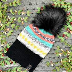 This double-layered knit beanie has a wide brim and a detachable faux fur pom pom. The inside of the hat is solid black, and you can reverse the hat entirely if you want to change up your look. This chunky knit hat was knitted on a hand-crank circular knitting machine. The faux leather tag and the faux fur pom on this hat are removable. This warm adult beanie is knitted with 100% acrylic yarn. This hat is made with a self-striping yarn; the item pictured is a representation of the item you will Cold Weather Knit Beanie Hat, Crochet Knit Hat For Cold Weather, Black Yarn Beanie, Black Knitted Acrylic Yarn Hat, Addi Machine, Sock Monkey Hat, Noir Uni, Circular Knitting Machine, Chunky Beanie