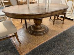 a dining table with chairs around it in a room filled with other furniture and decor