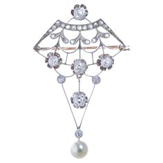 Edwardian era jewelry was all about femininity and elegance as this very romantic diamond and saltwater cultured pearl brooch in gold and silver top. Understated grandeur is clearly apparent in its feminine and refined design. A great addition to any antique collection, perfect for party season or to standout with personality and refinement. The design of the openwork features floral and geometric elements of Edwardian era, rendering of flower motif allows for leaf shapes and diamonds to be displayed to their finest. Five old cut diamonds total 2.12 carats of sparkling shimmer like snowflakes on spring blooms. Enhanced by twenty-one rose cut diamonds and 3 old European cut diamonds adding approx .77 Ct by spread. Constructed with dangling elements culminating into a romantic lustrous saltw Antique Cushion Cut Diamond, Antique Cushion Cut, Geometric Elements, Saltwater Pearls, Silver Top, One Rose, Silver Tops, Flower Motif, Edwardian Era