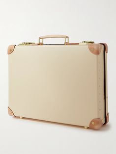 Globe-Trotter's attaché case pays homage to the 1920s era of exploration. Reinforced with leather trims and finished with gold-tone hardware, it's made from the label's signature vulcanised fibreboard that's designed to stand the test of time. The streamlined silhouette and smart materials will elevate your every travel outfit. Classic Travel Cases With Leather Trim, Vintage Formal Briefcase With Gold-tone Hardware, Vintage Briefcase With Gold-tone Hardware For Travel, Rectangular Briefcase With Leather Trim For Formal Use, Classic Briefcase With Gold-tone Hardware, Classic Rectangular Briefcase With Leather Trim, Classic Formal Briefcase With Leather Trim, Classic Briefcase With Gold-tone Hardware For Business Trips, Luxury Travel Briefcase With Brass Hardware