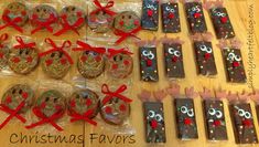 christmas favors are laid out on a table with red bows and ribbon around the cookies