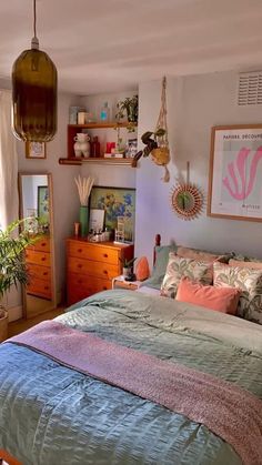 a bed room with a neatly made bed and lots of clutter on the wall