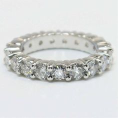 a white gold ring with five diamonds