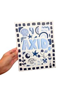 a hand holding up a card with the word axd on it in blue and white