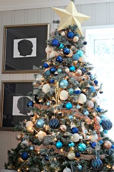 a decorated christmas tree with blue and white ornaments