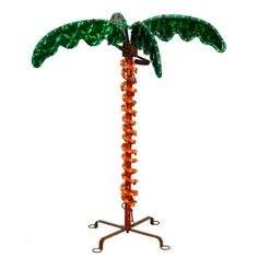 a glass palm tree on a metal stand with an orange beaded base and green leaves