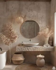 a bathroom with a sink, mirror and vases on the counter next to it