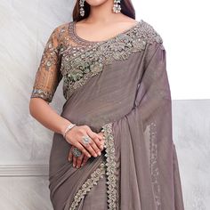 Grey colored saree is prettified with sequins floral embroidered work as shown which makes it appear classy. This saree is made of Georgette fabric which is accompanied with banglori silk blouse piece which you can customise as per your design/style. Women can buy this saree to wear for their parties, reception and events. Note:- The actual product may differ slightly in color and design from the one illustrated in the images when compared with computer or mobile screen. Measurements: Saree : Ge