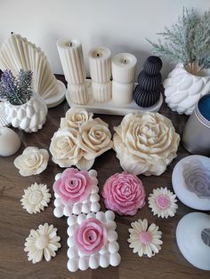 several different types of flowers and vases on a table