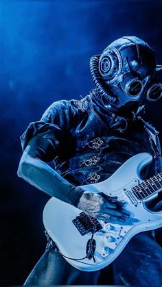 a man wearing a gas mask playing an electric guitar