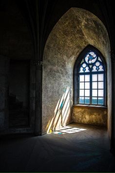 the sunlight is shining through an arched window