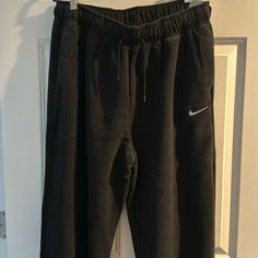 Nwt Nike Women’s Oversized Fit High Rise Fleece Sweat Pants With Drawstring And Front Side Pockets. Size: Medium Color: Black Nike Fleece Bottoms, Nike Winter Pants With Elastic Waistband, Nike Loungewear Trousers, Nike Fleece Pants For Loungewear, Nike Sweatpants For Loungewear, Nike Jogger Trousers For Loungewear, Nike Wide Leg Loungewear Pants, Nike Bottoms With Elastic Waistband For Winter, Nike Sweatpants For Winter Loungewear