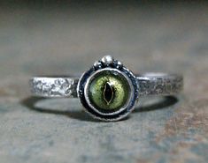 Taxidermy frog eyeball in solid sterling silver. No froggies were hurt in the process of making this ring, these are not real eyeballs! I custom made this ring from start to finish here in my shop in Eureka Springs. I have several more of these eyeballs in stock for custom orders. This ring is well made and is a comfortable fit. I can remake this ring in any size needed. It is a made to order piece so please check my policies for processing time. Feel free to contact me with any questions or com Silver Eye Ring, Eyeball Ring, Eye Ring Silver, Jewelry Evil Eye, Cultured Pearl Ring, Jewelry Making Classes, Eureka Springs, Silver Eye, Goth Style