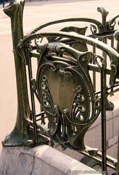 an iron fence with ornate designs on it