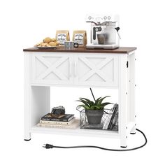 a white table with a potted plant and coffee maker on it's shelf