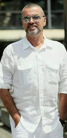 a man in white shirt and glasses standing