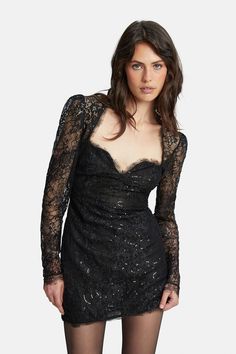 The Aurora Sequin Lace Mini Dress is a little black dress with attitude. Raw lace edging and the black colorway are balanced with sequins along the flower motifs and elegant long sleeves. A party favorite. Runs true to size Model is 5'8" and wears a size SMALL Bust cups fit a B-C cup Lace design Sequin embellishments Raw edging Long sleeves Mini hemline Fabrication: Main Sequin: 100% Polyethylene terephthalate. Main Base: 100% Nylon. Lining: 72% Nylon, 28% Elastane. Lace: 100% Nylon Designed in Flirty Scalloped Lace Mini Dress For Night Out, Fitted Mini Dress With Lace Trim For Party, Flirty Mini Lace Dress For Evening, Flirty Dress With Sheer Long Sleeves, Flirty Party Dress With Lace Sleeves, Flirty Dress With Long Sheer Sleeves, Fitted Lace Party Dress, Flirty Dresses With Sheer Long Sleeves, Flirty Long Sleeve Dresses With Sheer Sleeves