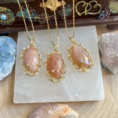 "These pretty Sunstone sparkly pendants are surrounded by micro paved sparkles and then hung on an 18\" gold colour necklace✨ The perfect gift for loved ones, friends or a treat to yourself.  Sunstone is said to be a stone of leadership, encouraging the wearer to be open, benevolent and willing to bestow blessings upon others. Also known as a stone of joy, sunstone is believed to inspire good nature and an enjoyment of life. Per order you will receive a free tumble stone which will be chosen and an oracle card.  Instructions for how to cleanse and charge will also be included. Please note that due to the fact these are natural stones, the colours may vary but they are all equally as beautiful.  Feel free to contact us if you have any questions at all. We are happy to offer more information Sunstone Gemstone Necklace For Gift, Sunstone Gemstone Necklace As A Gift, Gold Crystal Necklace With Stones For Jewelry Making, Gold Necklaces With Oval Pendant And Stones, Spiritual Gold Crystal Necklaces With Teardrop Pendant, Gold Spiritual Crystal Necklace With Teardrop Pendant, Spiritual Gold Crystal Necklace With Teardrop Pendant, Spiritual Gold Teardrop Pendant Crystal Necklace, Gold Crystal Spiritual Necklace With Stones