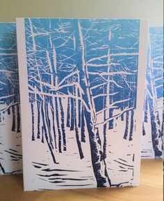 two cards with trees in the snow on them